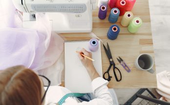woman-in-white-long-sleeve-shirt-sketching-on-white-printer