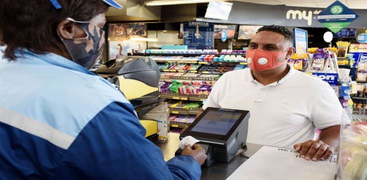 A South African commuter purchasing his long-distance bus ticket through Ticketpro ticketing service at Sasol Delight convenience store