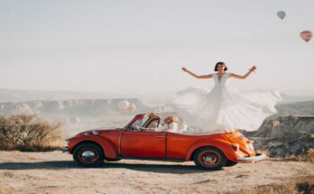 woman-standing-on-volkswagen-beetle