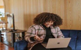 female-sitting-on-a-couch-using-laptop-computer