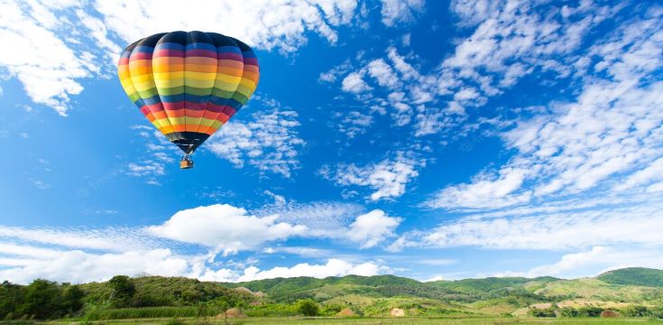 colorful-hot-air-balloon-green-field