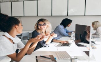 woman-gray-t-shirt-explains-something-blonde-female-friend-indoor-portrait-international-students-with-laptops-preparing-test-together