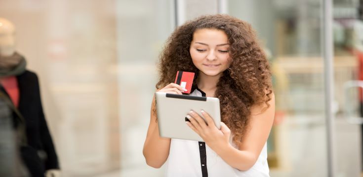 beautiful-young-woman-paying-by-credit-card-shopping