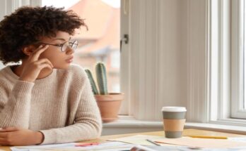 photo-contemplative-woman-with-afro-hairstyle-wears-round-spectacles-casual-warm-sweater