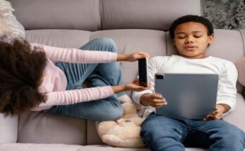siblings-using-tablet-mobile-home