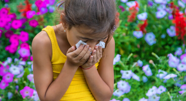 The child is seasonal allergy to flowers. Selective focus. Kid.
