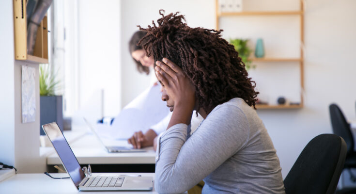 exhausted-african-american-woman-looking-laptop