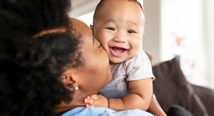 happy-african-american-mother-kissing-her-son