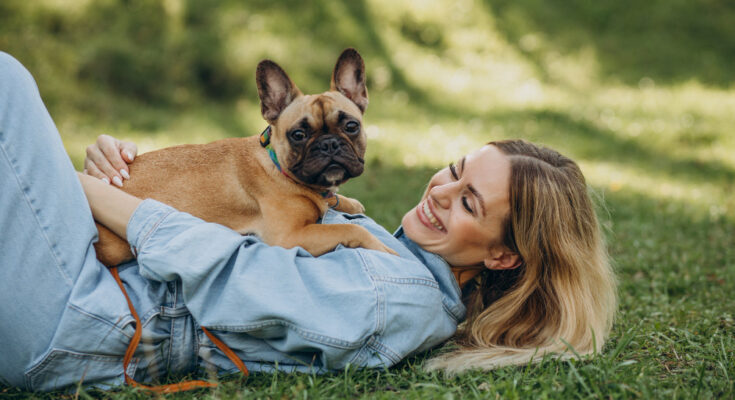 young-woman-with-her-pet-french-bulldog-park