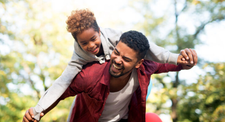 father-carrying-daughter-his-back-with-arms-spread