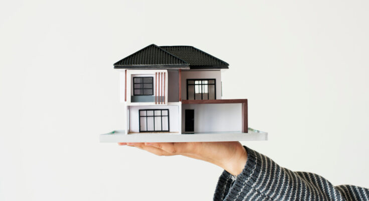 hand-presenting-model-house-home-loan-campaign