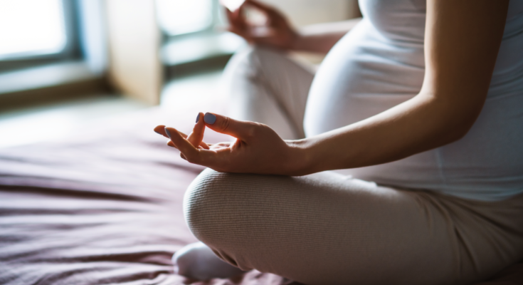 pregnant-woman-sitting-on-bed