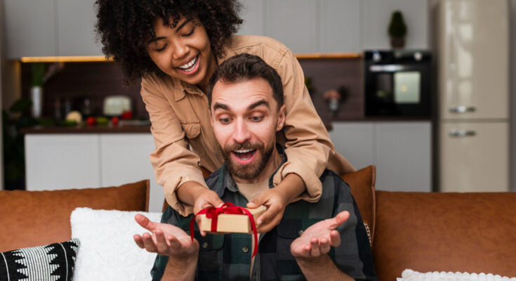 afro-american-woman-offering-gift-her-boyfriend